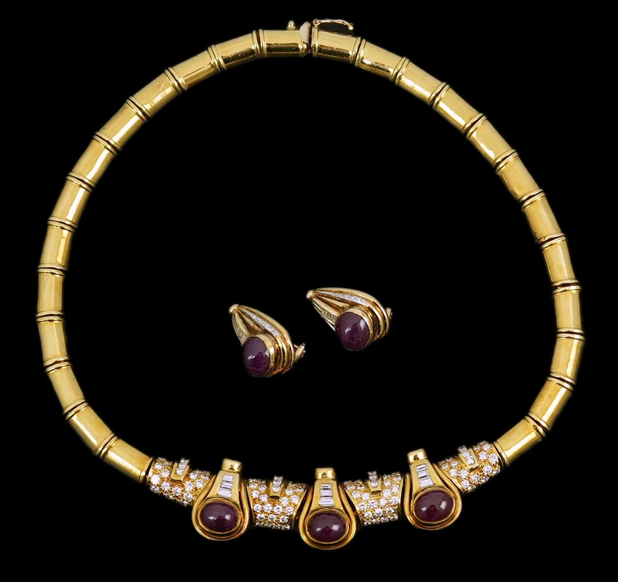 A modern 18k gold, cabochon ruby, round and baguette cut diamond cluster set torque necklace and a pair of matching earrings